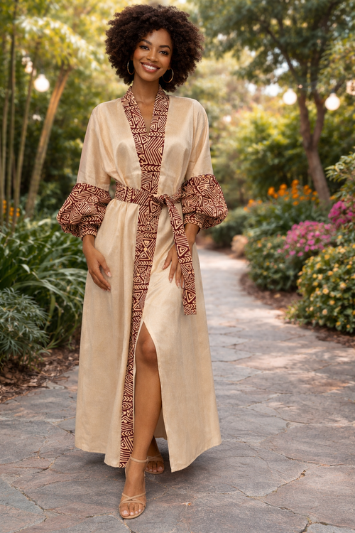 Woman wearing a long beige ethnic-inspired kimono featuring patterned statement sleeves and heritage-inspired