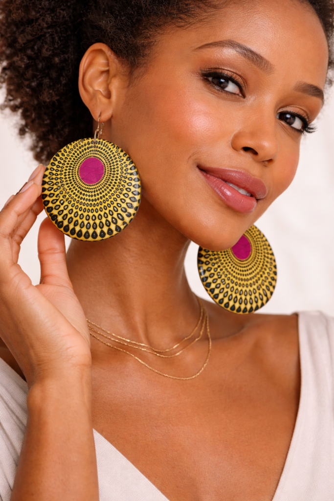 woman wearing yellow disc plexiglass statement earrings.